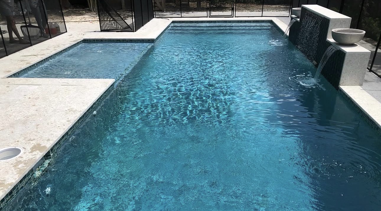 Pool with dark mosaic tile and sparkling water