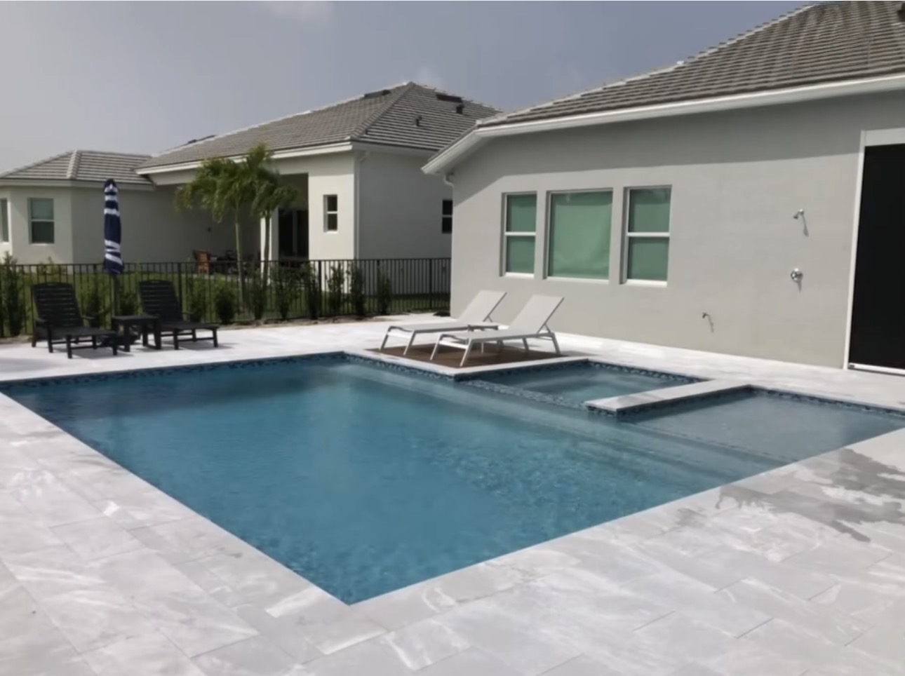 Pool and spa with travertine deck
