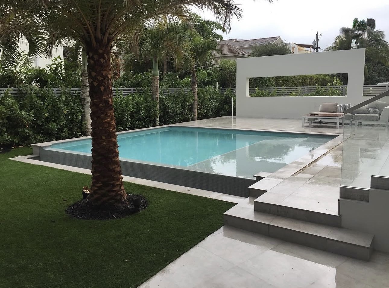 Modern infinity-edge pool with glass railing